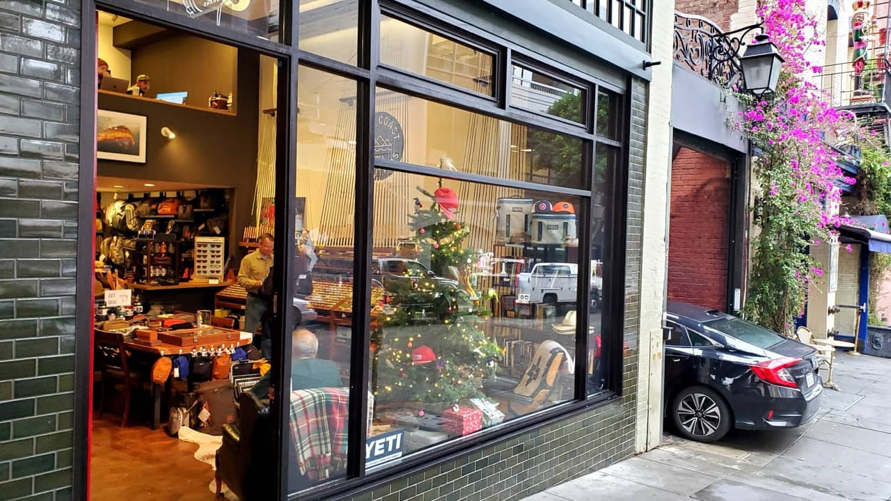 Black steel commercial storefront with large display window on a San Francisco alley facade